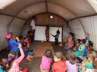 Syrian children who fled with their families from the northern countryside of Hama, attend a class at the makeshift school of "Zuhur al-Mustaqbal" (in Arabic "Flowers of the Future") in al-Jeneinah camp for displaced people in the village of Atme, in Syria's mostly rebel-held northern Idlib province, on October 1, 2018. Aaref WATAD / AFP