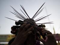 A devotee of the Loem Hu Thai Su shrine has multiple skewers pierced through his cheeks during the annual Vegetarian Festival in Phuket on October 12, 2018. Jewel SAMAD/AFP