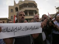 Druze residents of Majdal Shams in the Israeli-annexed Golan Heights protest against the municipal elections. Banner in Arabic reads: "Your rejection of the election is respecting your mind." (JALAA MAREY / AFP)