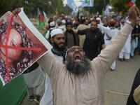 A Pakistani supporter of the Ahle Sunnat Wal Jamaat (ASWJ), a hardline religious party, holds an image of Christian woman Asia Bibi during a protest rally. (AAMIR QURESHI / AFP)