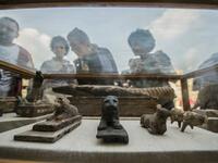 Diplomats and other viewers look at monuments displayed during a new discovery made by an Egyptian archaeological mission. (KHALED DESOUKI / AFP)