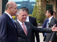 Jordan's King Abdullah II (R) greets Iraq's President Barham Salih at Amman's military airport, on November 15, 2018. 
Khalil MAZRAAWI / AFP