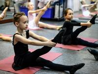 Girls attend a class at a ballet studio in Moscow on November 22, 2018. In a small studio in northern Moscow, parents and grandparents sit in a corridor waiting for children as young as three to finish their ballet class. 
Mladen ANTONOV / AFP