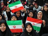 An Iranian woman holds a poster of Iran's late founder of the Islamic Republic, Ayatollah Ruhollah Khomeini
STR / AFP
