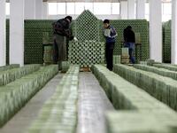 Syrian workers arrange olive soap bars in a factory on the outskirts of Aleppo 
LOUAI BESHARA / AFP
