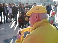 Abu Zakkour, Aleppo's so-called 'yellow man' eats a cob of corn in the northern Syrian city on February 11, 2019. Dressed in yellow from head-to-toe, Abu Zakkour is hailed as part of the "heritage" of the northern Syrian city of Aleppo, along with its medieval citadel and its ancient covered markets. 
LOUAI BESHARA / AFP
