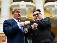 US President Donald Trump impersonator Russel White (L) and North Korean leader Kim Jong Un impersonator Howard X (R) pose together for photographs outside the Opera House in Hanoi on February 22, 2019. 
Manan VATSYAYANA / AFP