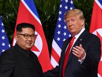 This file photo taken on June 12, 2018 shows US President Donald Trump (R) gesturing as he meets with North Korea's leader Kim Jong Un (L) at the start of their historic US-North Korea summit, at the Capella Hotel on Sentosa island in Singapore. 
SAUL LOEB / AFP