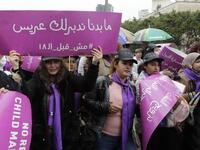 A Lebanese women hold a placards as they participate in a march against marriage before the age of 18, in the capital Beirut on March 2, 2019. The placard in Arabic reads " We do not want to find a groom for you, not before 18". 
ANWAR AMRO / AFP