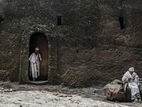 An Ethiopian Orthodox priest steps out of a room of the rock-hewn church of the House of the Saviour of the World in Lalibela, Ethiopia 
EDUARDO SOTERAS / AFP