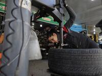Amina repairs a flat tyre at a car tyre's repair shop in Beirut on March 8, 2019. Amina has been working for 10 years in mechanics, specially in the tyres repair business. She considers it fulfilling as she always dreamt of doing that job.
JOSEPH EID / AFP