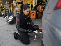 Amina repairs a flat tyre at a car tyre's repair shop in Beirut on March 8, 2019. Amina has been working for 10 years in mechanics, specially in the tyres repair business. She considers it fulfilling as she always dreamt of doing that job.
JOSEPH EID / AFP