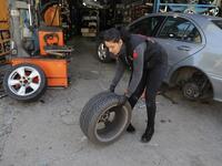 Amina repairs a flat tyre at a car tyre's repair shop in Beirut on March 8, 2019. Amina has been working for 10 years in mechanics, specially in the tyres repair business. She considers it fulfilling as she always dreamt of doing that job.
JOSEPH EID / AFP