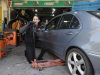 Amina repairs a flat tyre at a car tyre's repairshop in Beirut on March 8, 2019. Amina has been working for ten years in mechanics, specially in the tyres repair business. She considers it a fulfilement as she always dreamt of doing that job.
JOSEPH EID / AFP