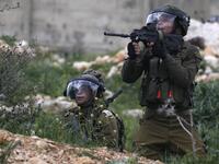 Israeli soldiers take aim at Palestinian protesters following a weekly demonstration against the expropriation of Palestinian lands in the village of Kfar Qaddum, near Nablus 
JAAFAR ASHTIYEH / AFP