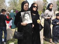 Iraqi-Kurds visit a grave site in Halabja near the monument for victims of the Halabja gas massacre 
Shwan MOHAMMED / AFP