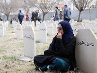 Iraqi-Kurds visit a grave site in Halabja near the monument for victims of the Halabja gas massacre 
Shwan MOHAMMED / AFP