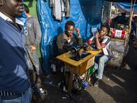 Sub-Saharan migrants sit by a sewing machine at the Oulad Ziane migrant camp in Casablanca on March 27, 2019. 
FADEL SENNA / AFP