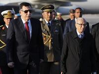 Tunisian President Beji Caid Essebsi (R) welcomes Libya's Prime Minister Fayez al-Sarraj upon his arrival at Tunis-Carthage international airport on March 30, 2019, to attend the Arab Summit tomorrow. 
Hussein Malla / POOL / AFP