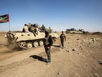 Fighters of the Hashed al-Shaabi (Popular Mobilization) paramilitaries are seen riding on infantry-fighting vehicles during the advance towards villages between the northern Iraqi cities of Hawija and Kirkuk on October 6, 2017
AHMAD AL-RUBAYE / AFP