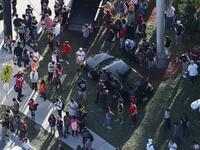 People wait for loved ones as they are brought out of the Marjory Stoneman Douglas High School after a shooting at the school that reportedly killed and injured multiple people on Feb. 14, 2018 in Parkland, Florida. Numerous law enforcement officials continue to investigate the scene.
(JOE RAEDLE / GETTY IMAGES NORTH AMERICA / AFP)