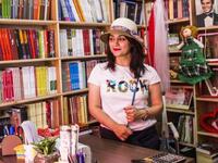 On Baghdad's famous al-Mutanabbi Street, bookstore owner Bara'a al-Bayati welcomes her customers with a smile (Twitter)