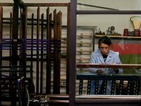 This picture shows a woman at work in the laboratory of Antico setificio Fiorentino ancient silk factory in Florence. 
Tiziana FABI / AFP