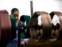 This picture shows a woman at work in the laboratory of the ancient silk factory of Antico setificio Fiorentino in Florence. 
Tiziana FABI / AFP