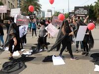 Activists hold banners against sexual assaults during the 16th edition of the Beirut Marathon on November 11, 2018. 
ANWAR AMRO / AFP