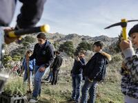 An activist from Lebanese NGO Jouzour Loubnan ("Roots of Lebanon") holds in his hand young a cedar to be planted on the slopes of the Jaj Cedar Reserve Forest in the Lebanon mountains.
JOSEPH EID / AFP