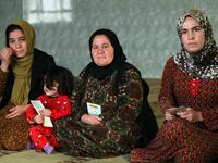 Women and young girls listen to Rasul (not pictured), an Iraqi Kurdish activist with the non-profit organisation WADI, as she peaks about the harms of genital mutilation in Sharboty Saghira.
SAFIN HAMED / AFP