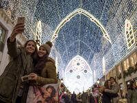 Two women take a selfie photo at Larios street, adorned with Christmas lights, in Malaga on December 19, 2018. 
JORGE GUERRERO / AFP