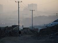 In this photograph an Afghan resident walks along a dirt path amid heavy smog conditions in Afghanistan's capital Kabul. 
WAKIL KOHSAR / AFP