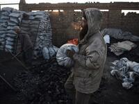 In this picture, Afghan day labourers work at a coal yard amid heavy smog conditions in the outskirts of Kabul. 
WAKIL KOHSAR / AFP