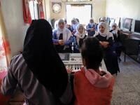 Children attend a music class at the Al-Nawras school in Taez, Yemen's third city, in the country's southwest
AHMAD AL-BASHA / AFP