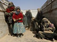 People who fled battles between Syrian Democratic Forces (SDF) and ISIS fighters in the Syrian village of Baghouz, arrive after crossing a desert in the back of a truck to a region controlled by the SFD in the countryside of the Deir Ezzor province 
Delil SOULEIMAN / AFP