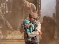 People who fled battles between Syrian Democratic Forces (SDF) and ISIS fighters in the Syrian village of Baghouz, arrive after crossing a desert in the back of a truck to a region controlled by the SFD in the countryside of the Deir Ezzor province. Delil SOULEIMAN / AFP