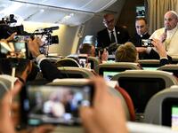 Pope Francis speaks to reporters aboard a plane on his way to Abu Dhabi on February 3, 2019. 
Vincenzo PINTO / AFP