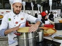 An Algerian chef prepares couscous during the 2nd edition of the International Couscous Festival at the Moufdi Zakaria Palace of Culture in  Algeria
RYAD KRAMDI / AFP