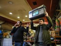 An auctioneer shows items to the audience at an auction house in Istanbul's Balat district. 
OZAN KOSE / AFP