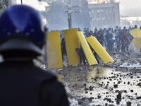 Algerian protesters use makeshift barriers during clashes with security forces amidst protests against ailing President Abdelaziz Bouteflika's bid for a fifth term in power in the capital 
RYAD KRAMDI / AFP