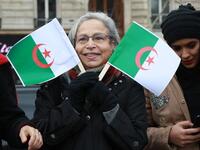 A woman holds Algerian flags during a rally against ailing Algerian president's decision to stand for a fifth term in office
JACQUES DEMARTHON / AFP