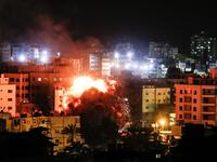 Fire and smoke billow above buildings in Gaza City during reported Israeli strikes on March 25, 2019. Israel's military launched strikes on Hamas targets in the Gaza Strip today, the army and witnesses said, hours after a rocket from the Palestinian enclave hit a house and wounded seven Israelis.
Mahmud Hams / AFP