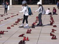 Israelis walk past an installation of red shoes during a rally against domestic violence in the Israeli coastal city of Tel Aviv on December 4, 2018 (Twitter)