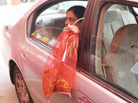 A woman holds bags filled with locusts, sold as food, at a market in Kuwait City (kuwaittimes)
