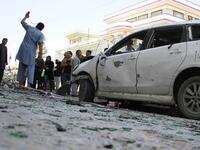 Afghan police officers inspect the scene of the suicide bomb attack that struck a voters registration centre on Sunday. (AFP Photo)