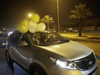 A Saudi woman and her friends celebrate her first time driving on a main street of Khobar City on her way to Kingdom of Bahrain on June 24, 2018.
HUSSAIN RADWAN / AFP