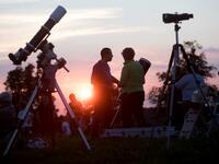 People gather as they wait for the sun to go down and the appearance of the 'Blood moon' in Vienna, Austria on July 27, 2018. The 'Blood moon' total lunar eclipse, is the longest of the 21st century.
GEORG HOCHMUTH / APA / AFP
