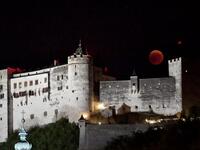 This picture shows the full moon during a 'blood moon' eclipse over the Festung Hohensalzburg castle in Salzburg on July 27, 2018. (AFP/APA/ BARBARA GINDL)