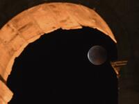 This picture shows the full moon during a 'blood moon' eclipse behind the ancient Colosseum on July 28, 2018 in Rome. (AFP/Tiziana FABI)
